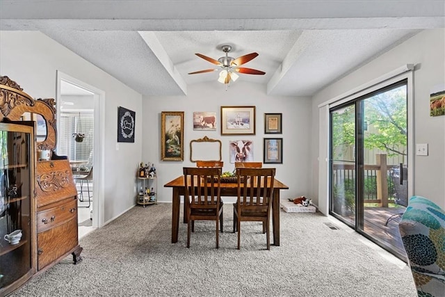 dining room featuring light colored carpet, ceiling fan, a textured ceiling, and baseboards