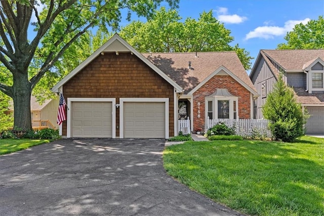 view of front of property featuring driveway, a garage, and roof with shingles