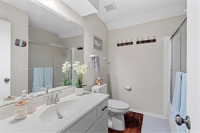 full bath with a shower with shower door, toilet, wood finished floors, and vanity