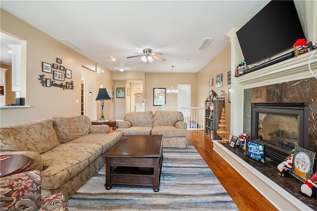 14 Emerald Shore Dr, Lake Tapawingo, MO 64015 - living room featuring ceiling fan, wood finished floors, a fireplace, and a chandelier