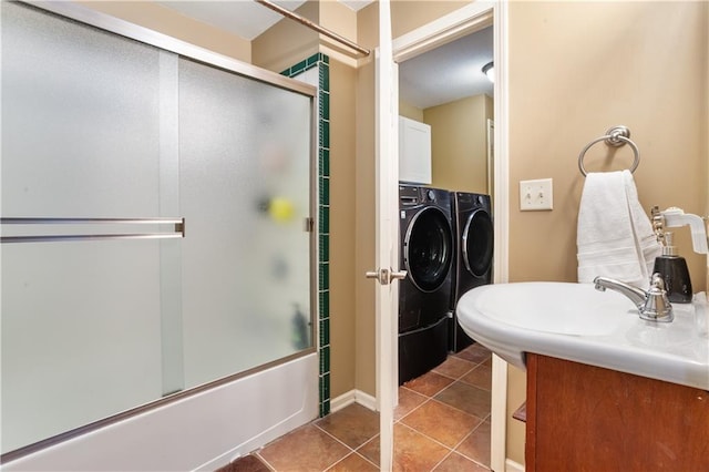14 Emerald Shore Dr, Lake Tapawingo, MO 64015 - full bath featuring washing machine and clothes dryer, tile patterned floors, bath / shower combo with glass door, and a sink