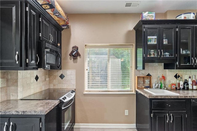 14 Emerald Shore Dr, Lake Tapawingo, MO 64015 - kitchen featuring dark cabinets, black appliances, and a sink