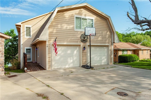 14 Emerald Shore Dr, Lake Tapawingo, MO 64015 - view of property exterior with a gambrel roof, concrete driveway, and a garage