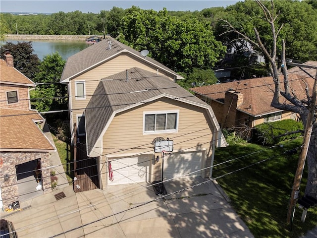 14 Emerald Shore Dr, Lake Tapawingo, MO 64015 - view of front facade with driveway, a gambrel roof, a garage, fence, and a water view