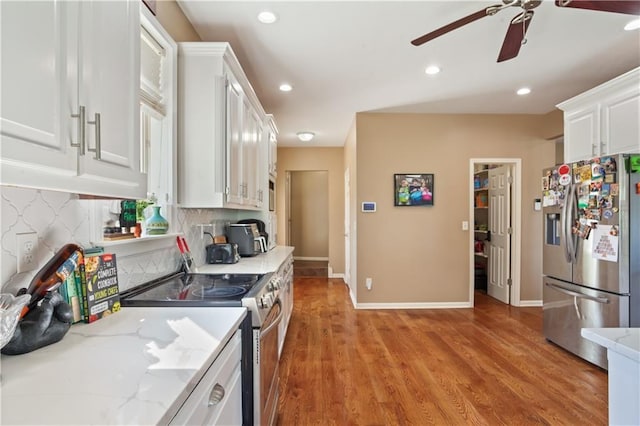 14 Emerald Shore Dr, Lake Tapawingo, MO 64015 - kitchen with appliances with stainless steel finishes, ceiling fan, white cabinetry, decorative backsplash, and recessed lighting