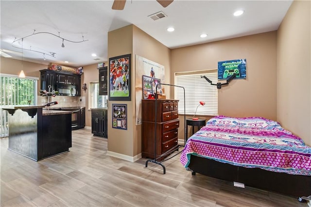 14 Emerald Shore Dr, Lake Tapawingo, MO 64015 - bedroom with multiple windows, light wood-type flooring, and recessed lighting