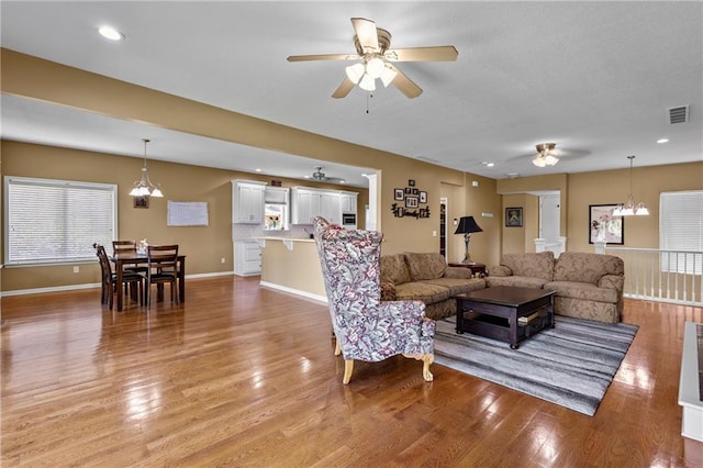 14 Emerald Shore Dr, Lake Tapawingo, MO 64015 - living room featuring ceiling fan, light wood-style floors, and a chandelier