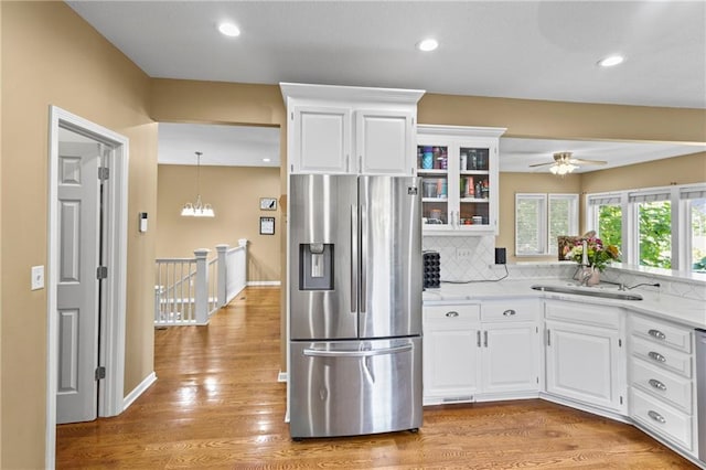14 Emerald Shore Dr, Lake Tapawingo, MO 64015 - kitchen with stainless steel refrigerator with ice dispenser, backsplash, ceiling fan, glass insert cabinets, and white cabinetry