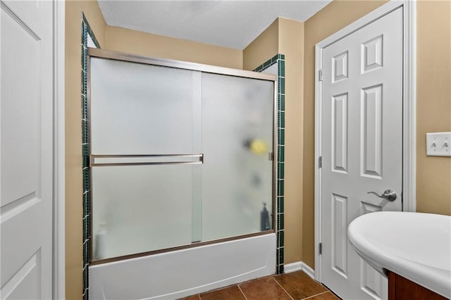 14 Emerald Shore Dr, Lake Tapawingo, MO 64015 - full bathroom featuring shower / bath combination with glass door, tile patterned flooring, and a textured ceiling
