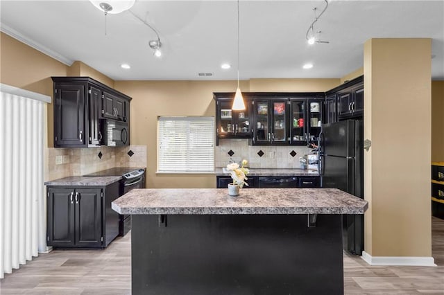 14 Emerald Shore Dr, Lake Tapawingo, MO 64015 - kitchen featuring black appliances, light wood-type flooring, a center island, tasteful backsplash, and recessed lighting