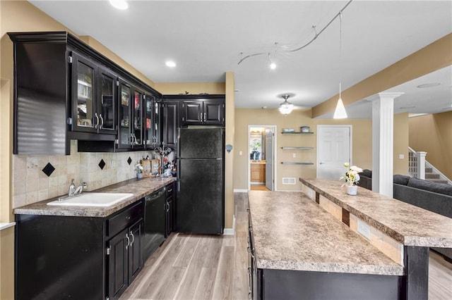 14 Emerald Shore Dr, Lake Tapawingo, MO 64015 - kitchen with black appliances, dark cabinetry, light wood-type flooring, decorative columns, and recessed lighting