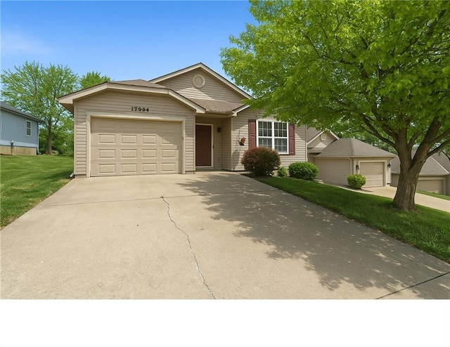 ranch-style house with a garage, a front lawn, and driveway