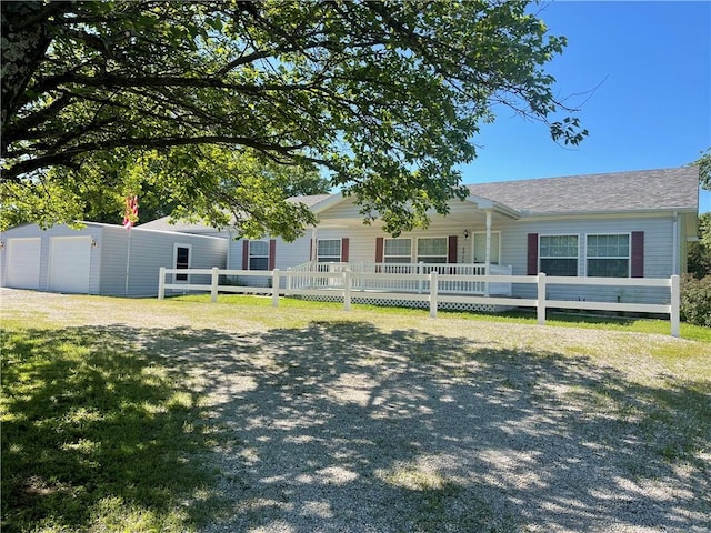 view of front of property featuring fence and a garage