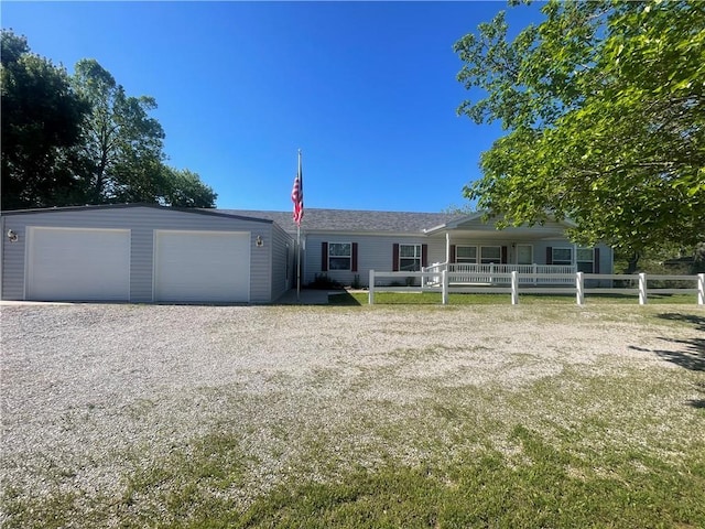 ranch-style home featuring a garage and fence