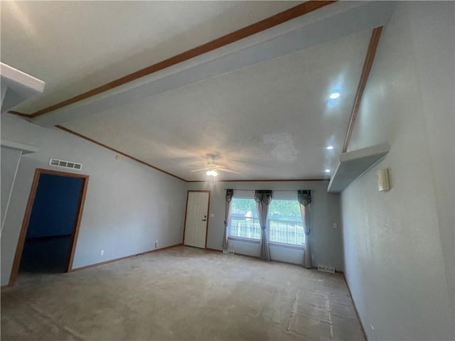 carpeted empty room with baseboards, a ceiling fan, and visible vents