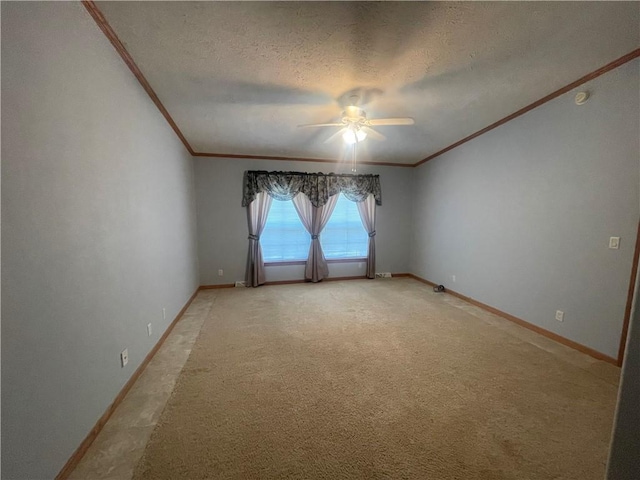 empty room featuring crown molding, a textured ceiling, baseboards, and a ceiling fan