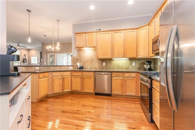 kitchen featuring appliances with stainless steel finishes, ornamental molding, light brown cabinetry, light wood-style flooring, and a peninsula