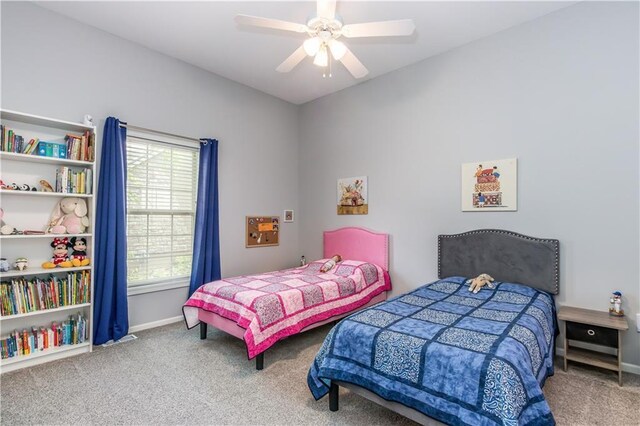 carpeted bedroom with baseboards and ceiling fan
