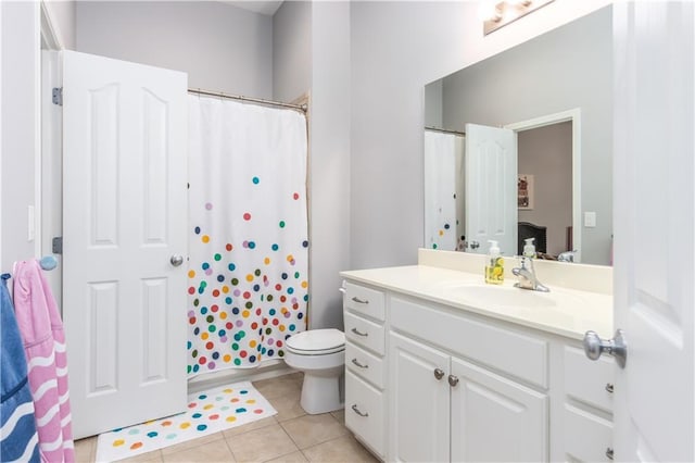 bathroom featuring tile patterned flooring, toilet, vanity, and a shower with shower curtain