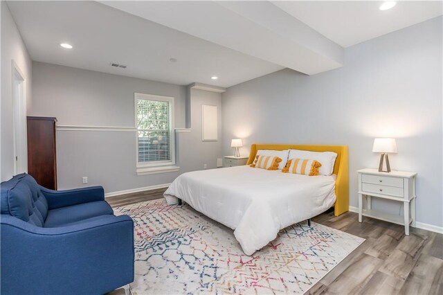 bedroom with wood finished floors, baseboards, and recessed lighting