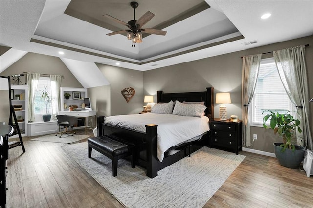 21511 W 100th Ter, Lenexa, KS 66220 - bedroom with a raised ceiling, multiple windows, wood finished floors, a desk, and recessed lighting