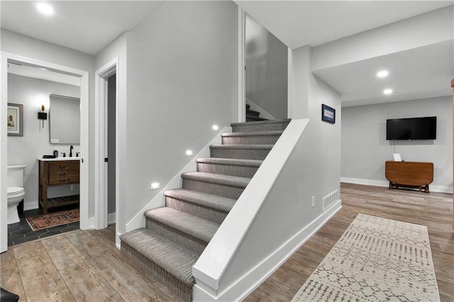 21511 W 100th Ter, Lenexa, KS 66220 - stairs with wood finished floors, baseboards, and recessed lighting