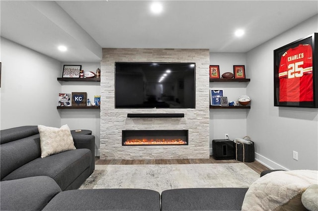 21511 W 100th Ter, Lenexa, KS 66220 - living room with wood finished floors, a stone fireplace, baseboards, and recessed lighting