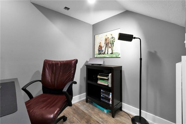 21511 W 100th Ter, Lenexa, KS 66220 - home office with wood finished floors, vaulted ceiling, and baseboards