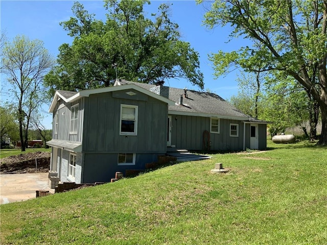 8480 NW High St Unit B, Amsterdam, MO 64723 - view of front of home featuring board and batten siding, an attached garage, driveway, and a front yard