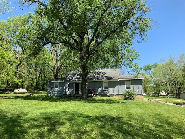 8480 NW High St Unit B, Amsterdam, MO 64723 - back of house featuring a lawn and board and batten siding