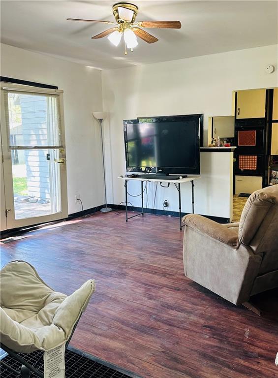 8480 NW High St Unit B, Amsterdam, MO 64723 - living area featuring baseboards, ceiling fan, and wood finished floors