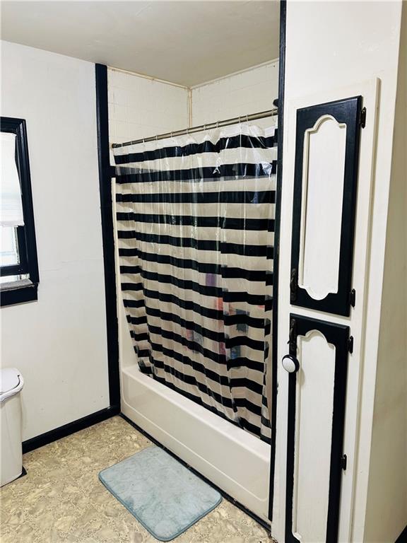 8480 NW High St Unit B, Amsterdam, MO 64723 - full bath with baseboards, shower / bath combination with curtain, and toilet