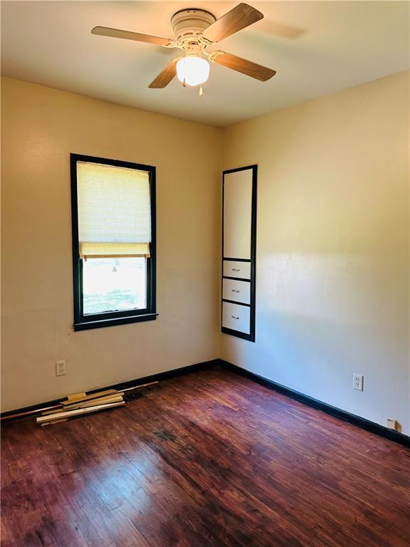 8480 NW High St Unit B, Amsterdam, MO 64723 - unfurnished room featuring baseboards, ceiling fan, and wood finished floors