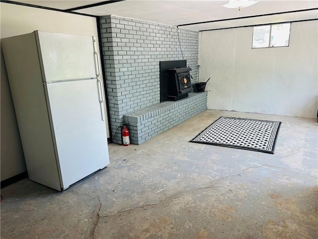 8480 NW High St Unit B, Amsterdam, MO 64723 - below grade area featuring freestanding refrigerator and a wood stove