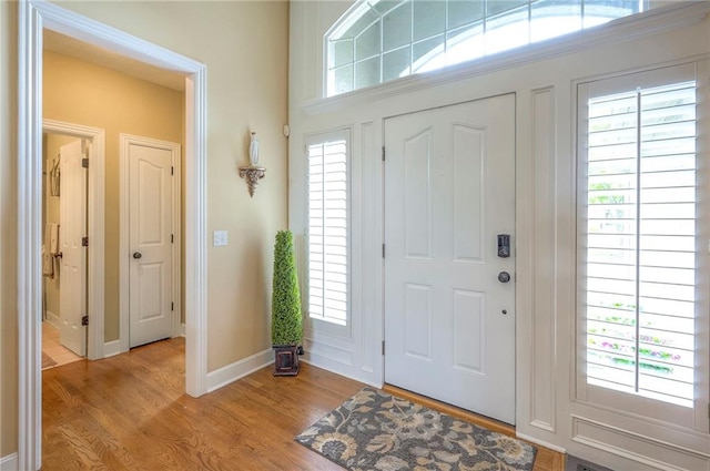 2945 W 143rd Ter, Leawood, KS 66224 - entryway featuring light wood-style floors, baseboards, and healthy amount of natural light