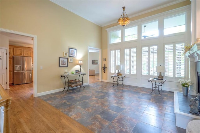 2945 W 143rd Ter, Leawood, KS 66224 - foyer featuring healthy amount of natural light, a high ceiling, baseboards, and ornamental molding