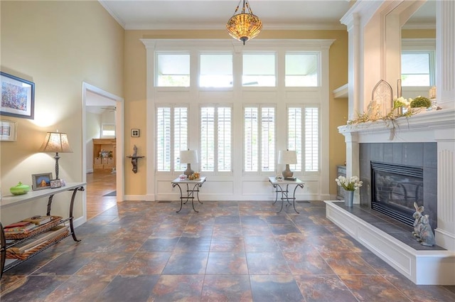 2945 W 143rd Ter, Leawood, KS 66224 - foyer entrance with a tiled fireplace, baseboards, ornamental molding, stone finish floors, and a towering ceiling