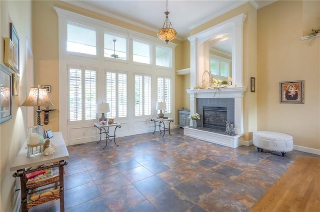 2945 W 143rd Ter, Leawood, KS 66224 - living room with a tiled fireplace, crown molding, baseboards, and stone tile flooring