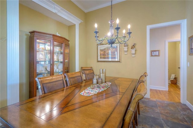 2945 W 143rd Ter, Leawood, KS 66224 - dining area with a chandelier, stone finish flooring, baseboards, and crown molding
