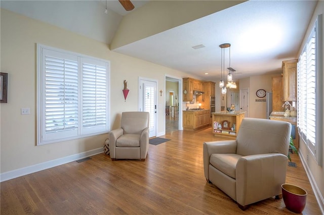 2945 W 143rd Ter, Leawood, KS 66224 - living room with a ceiling fan, baseboards, healthy amount of natural light, wood finished floors, and vaulted ceiling