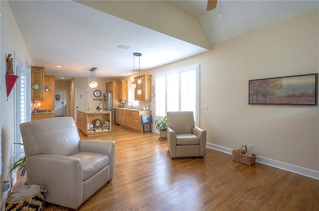 2945 W 143rd Ter, Leawood, KS 66224 - living area with baseboards, light wood-type flooring, and ceiling fan