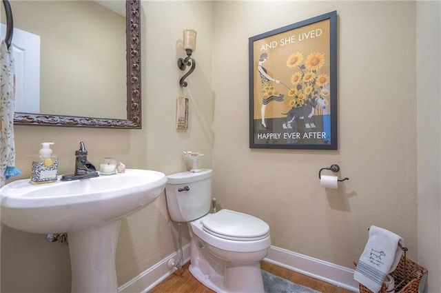 2945 W 143rd Ter, Leawood, KS 66224 - bathroom with toilet, wood finished floors, and baseboards