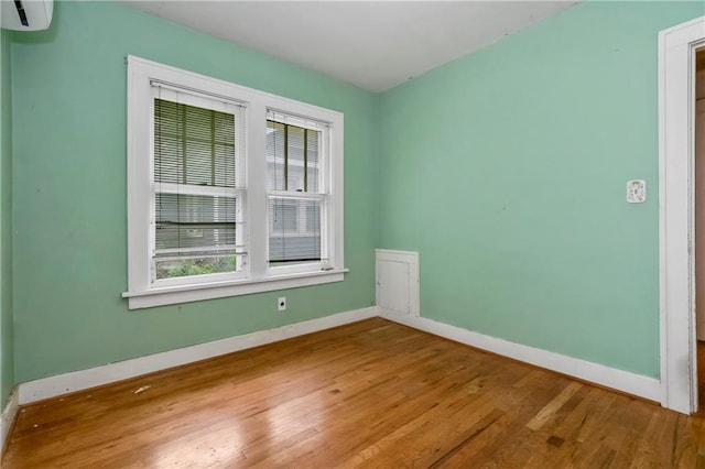 empty room featuring baseboards and wood finished floors