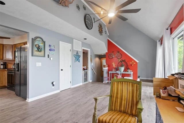sitting room featuring a ceiling fan, light wood-style floors, and baseboards