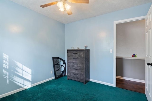 unfurnished bedroom with carpet floors, baseboards, and a textured ceiling