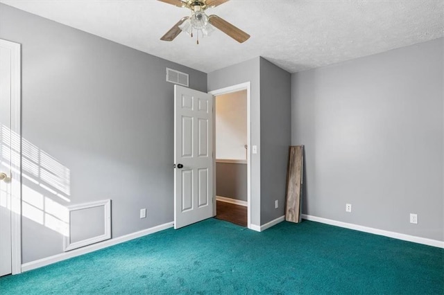 unfurnished bedroom with a ceiling fan, a textured ceiling, baseboards, carpet flooring, and visible vents