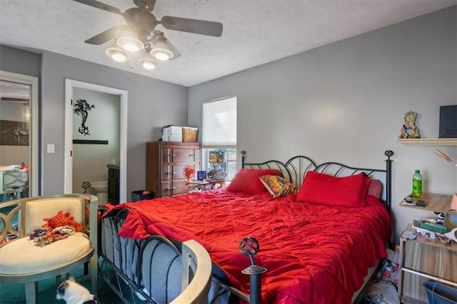 bedroom with ceiling fan and a textured ceiling