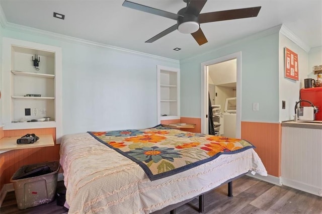 bedroom with ornamental molding, a wainscoted wall, and wood finished floors
