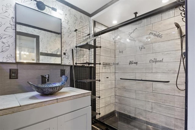 bathroom featuring crown molding, vanity, a stall shower, and wallpapered walls