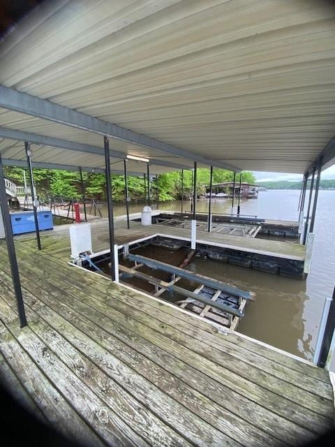 dock area with a water view and boat lift